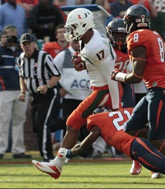 Miami quarterback Stephen Morris (17) runs towards the end zone as he is pursued by Virginia safeties Anthony Harris (8) and Brandon Phelps (21)...