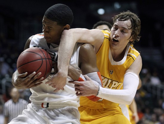 Miami's DeQuan Jones (5) and Valparaiso's Ryan Broekhoff (45) battle for the ball during the first half. (AP Photo/J Pat Carter)