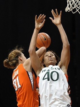 Miami's Shawnice Wilson, right, and Clemson's Lindsey Mason, left, fight for a rebound during the second half of an NCAA college basketball game...