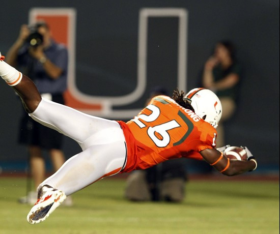 Miami defensive back Ray-Ray Armstrong dives into the end zone after intercepting a pass during the first half of an NCAA college football game...