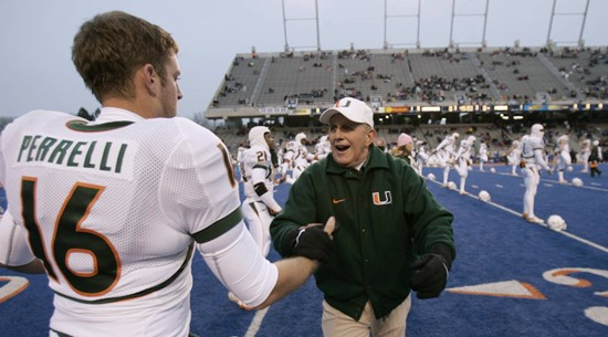 Miami coach Larry Coker greets quarterback Matt Perrelli during warmup prior to the MPC Computers Bowl. (AP Photo/Douglas C. Pizac)