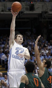 North Carolina's Tyler Zeller (44) shoots as Miami's Shane Larkin (0) and Trey McKinney Jones (4) defend during the first half of an NCAA college...