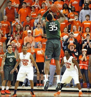 Miami's Kenny Kadji (35) shoots and scores a 3-point basket against Clemson in the final minute of an NCAA college basketball game, Sunday, Feb. 17,...