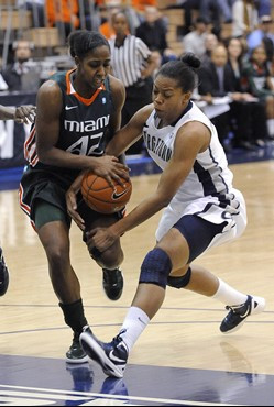 Miami guard Shenise Johnson, left, and Georgetown Adria Crawford vie for the ball as Wilson tries to drive to the basket during first half of an NCAA...