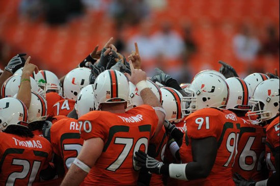 University of Miami Hurricanes join hands showing team spirit in a game against the University of Central Florida Knights at Dolphin Stadium on...