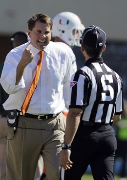 Miami head coach Al Golden, left, talks to an official during the first half against North Carolin. (AP Photo/Gerry Broome)