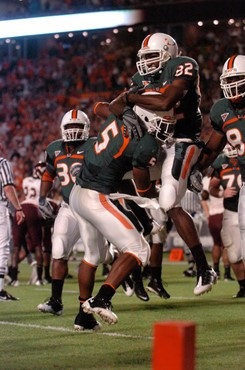 University of Miami Hurricanes running back Javarris James #5 and University of Miami Hurricanes defensive lineman Josh Holmes #92 celebrate a...