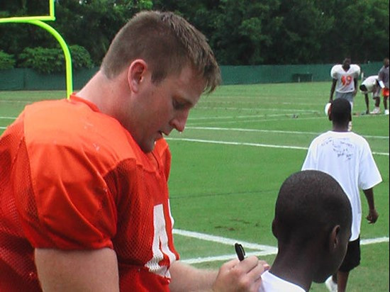 John Rochford signs a lucky student's t-shirt.