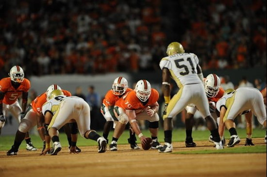 Univeristy of Miami Hurricanes guard A.J. Trump #70 and quarterback Jacory Harris #12 assess the defense in a game against the Georgia Tech Yellow...