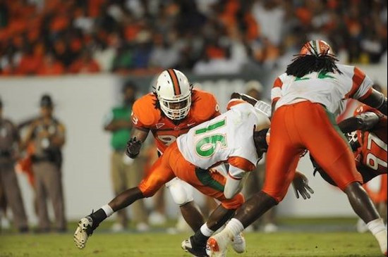 University of Miami Hurricanes defensive lineman Adewale Ojomo #97 and Luther Robinson #93 sack FAMU quarterback Martin Ukpai in a game against the...