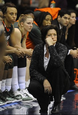 Miami coach Katie Meier and her player watch during the team's 71-46 loss to Georgetown in an NCAA college basketball game Wednesday, Dec. 21, 2011,...