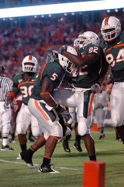 University of Miami Hurricanes running back Javarris James #5 and University of Miami Hurricanes defensive lineman Josh Holmes #92 celebrate after a...