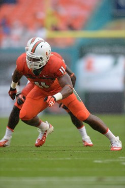 Defensive lineman David Gilbert #11 and The University of Miami Hurricanes plays in a game against the Virginia Cavaliers at Sun Life Stadium on...