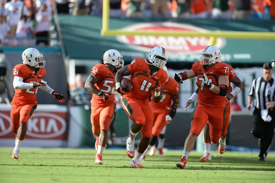 Defensive lineman David Gilbert #11 and The University of Miami Hurricanes plays in a game against the Virginia Cavaliers at Sun Life Stadium on...